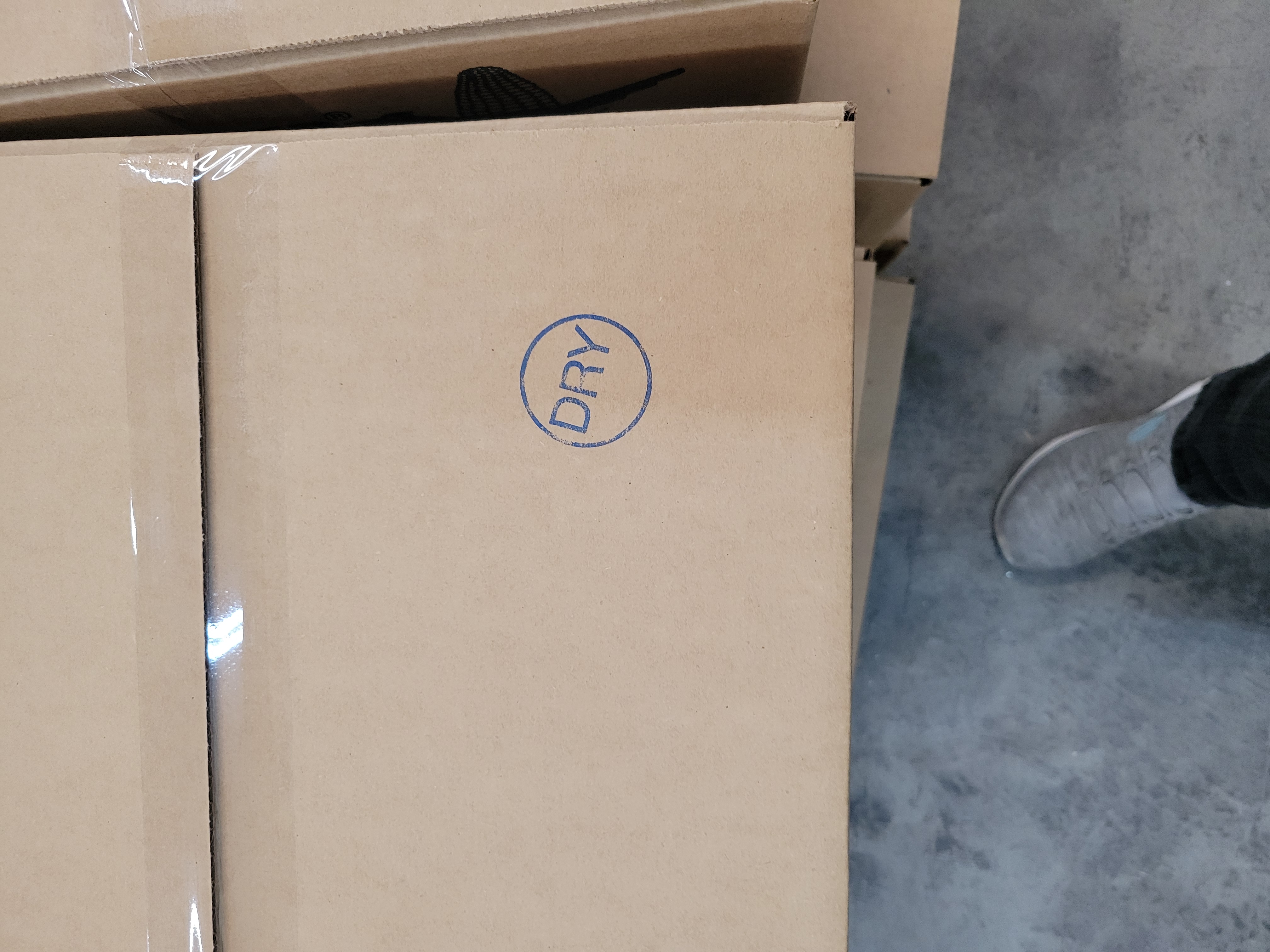 Taped shut cardboard box with the word dry stamped on it.